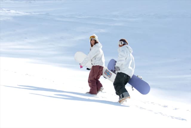 Skiers walking up a groomed run in Basye, VA