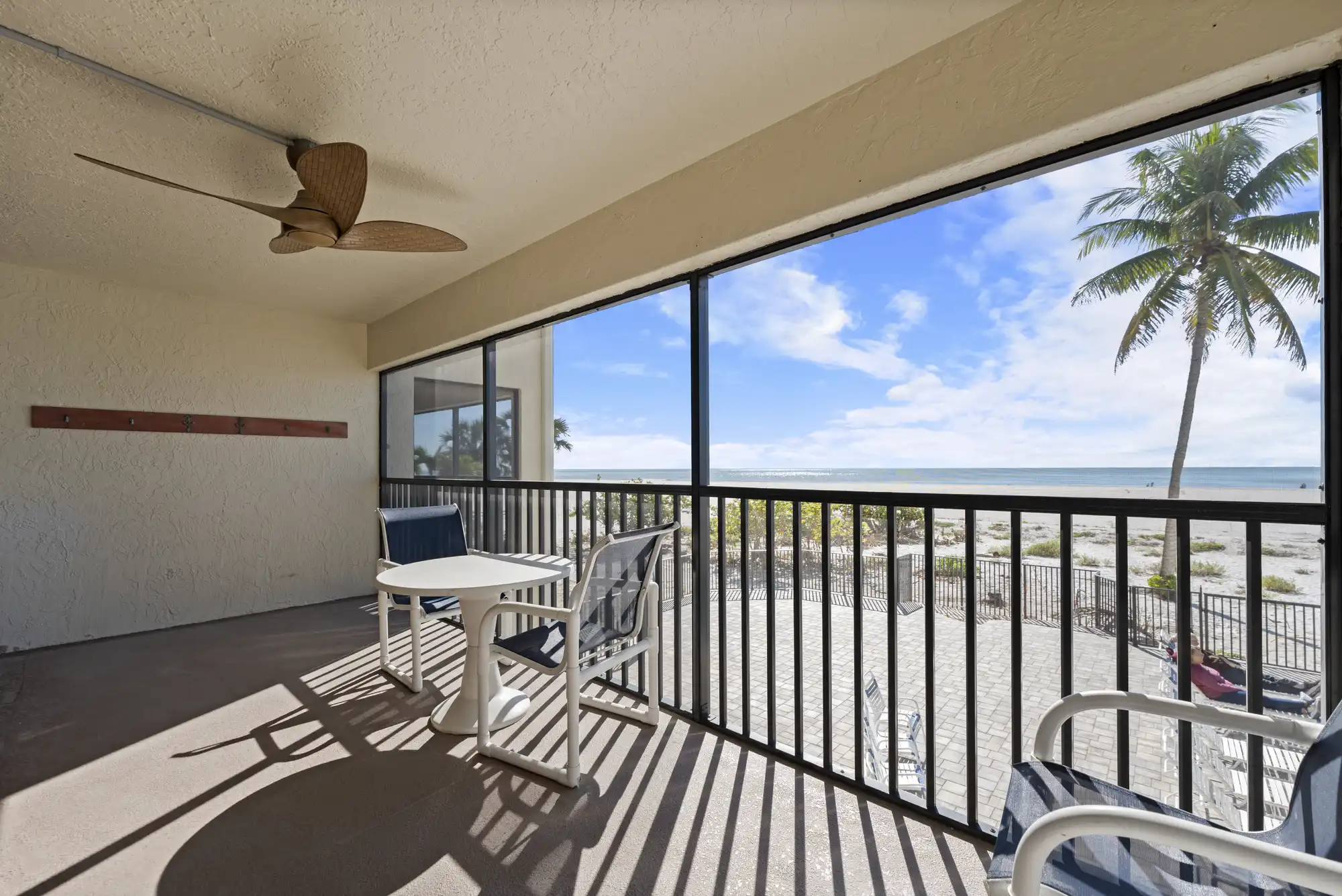 Aerial view of a wide sandy beach and coastline with nearby beachfront buildings